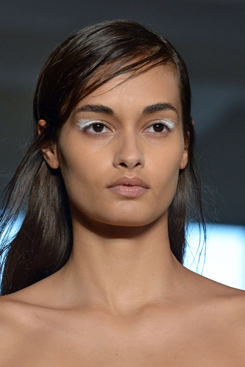 Inspired by abstract art, makeup maestro and Shiseido Artistic Director Dick Page painted a "smudge" on the models' eyelids at the Zero + Maria Cornejo show in New York. Using jagged brush strokes he applied a white cream pigment to the peepers. We love this look against a strong brow (although we'd add mascara!).