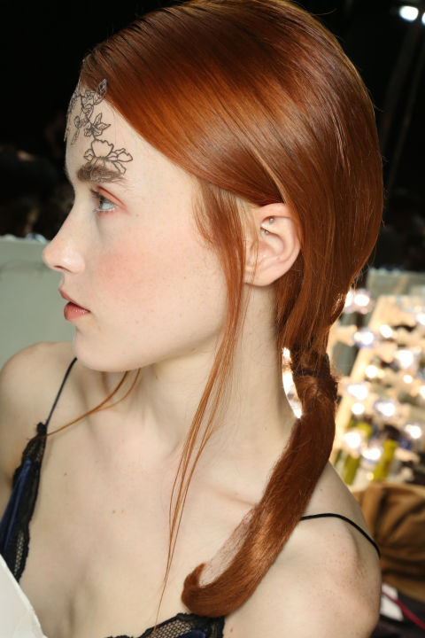 The ethereal beauty look at Bora Aksu came courtesy of FaceLace designs accessorising the models' foreheads and temples. Stunning! The low, loose ponytails by the KMS team also oozed romance, but the considered side partings made the look more modern.